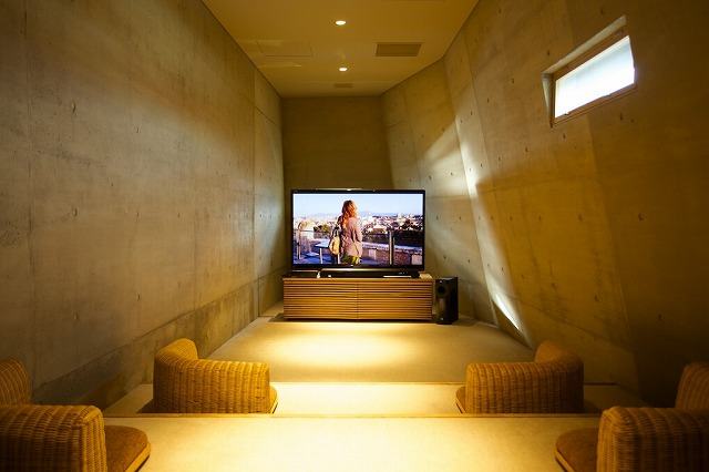 A theater room with a 60-inch screen and Apple TV for movie watching, with the option to pair with your iPhone.