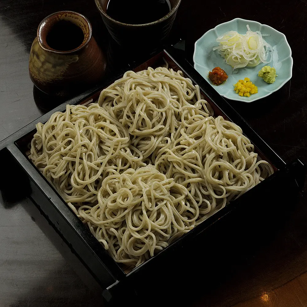 The seiro soba is carefully stone-milled in-house over the course of a week, resulting in a clear, refined flavor that eliminates any harshness, allowing the pure essence of buckwheat to shine through.