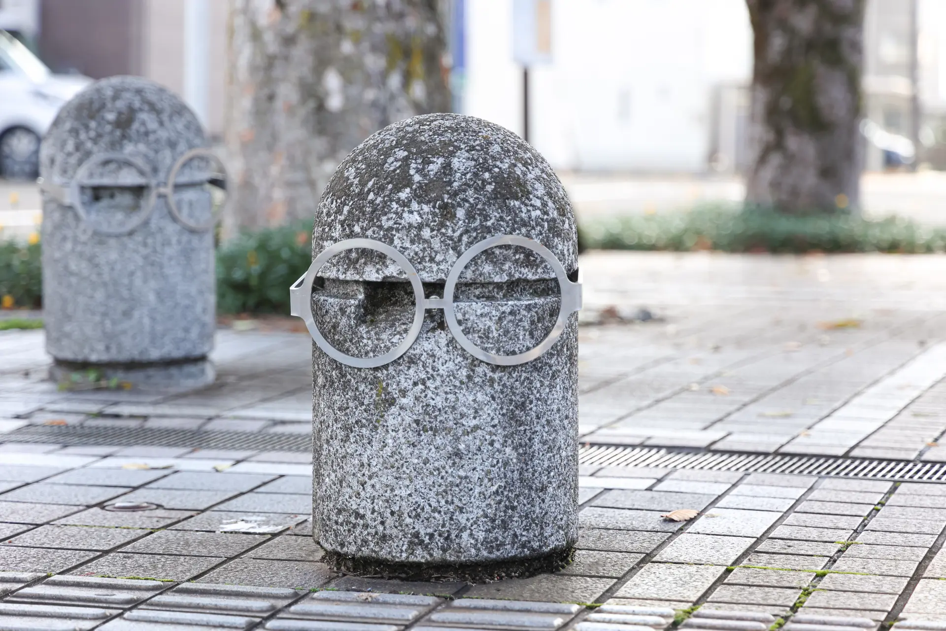 A bollard wearing eyeglasses stands along the path. Just by adding glasses, it somehow looks a bit more stylish!