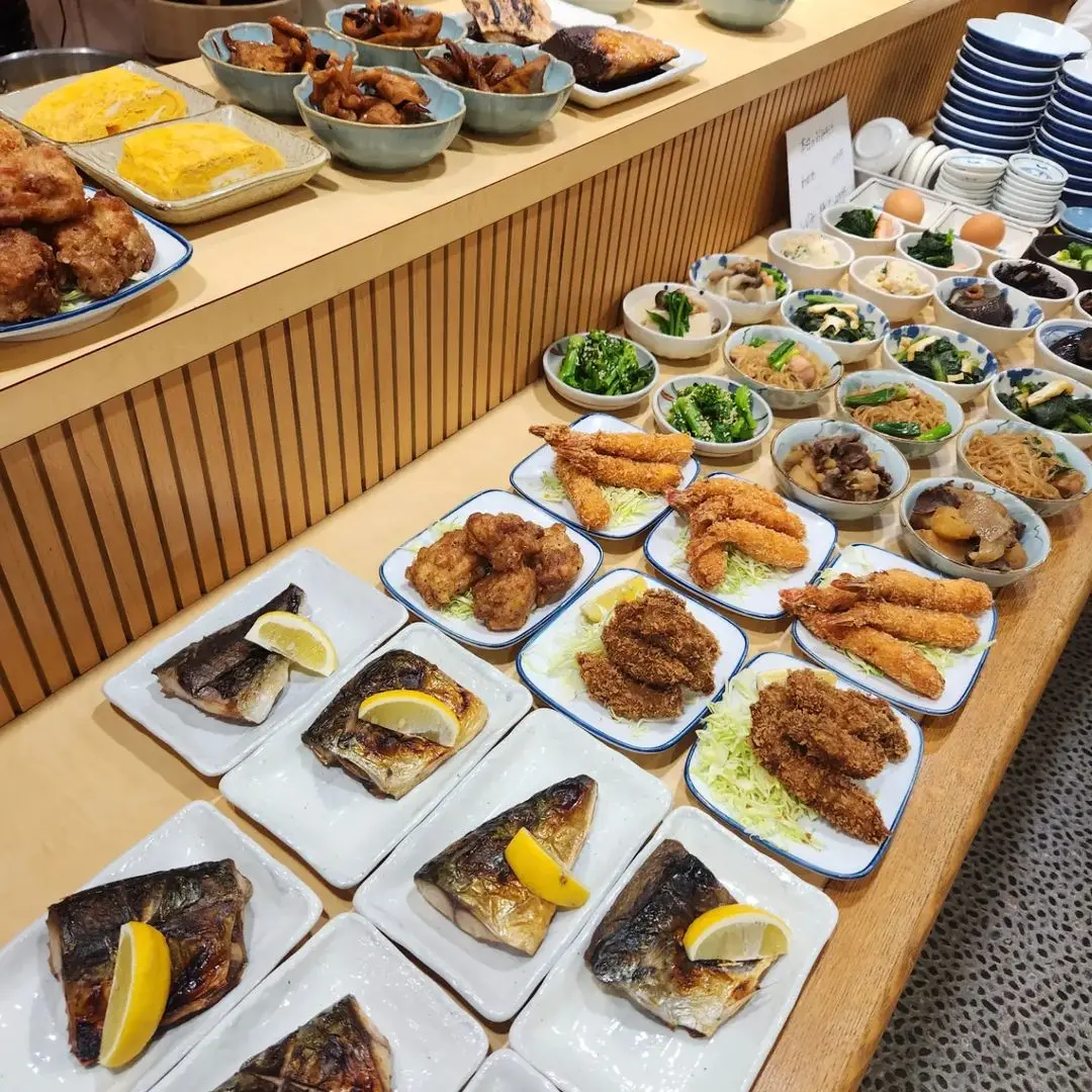 The counter is filled with an array of side dishes and small plates.