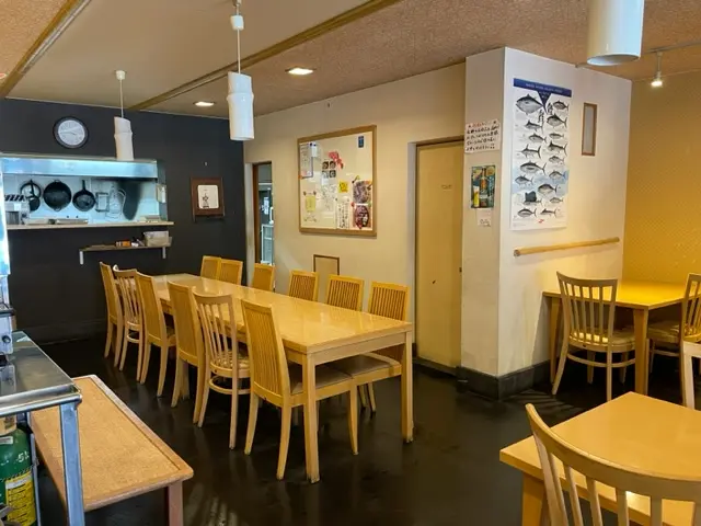 A cozy little restaurant with approximately 20 seats, offering both table and counter seating.