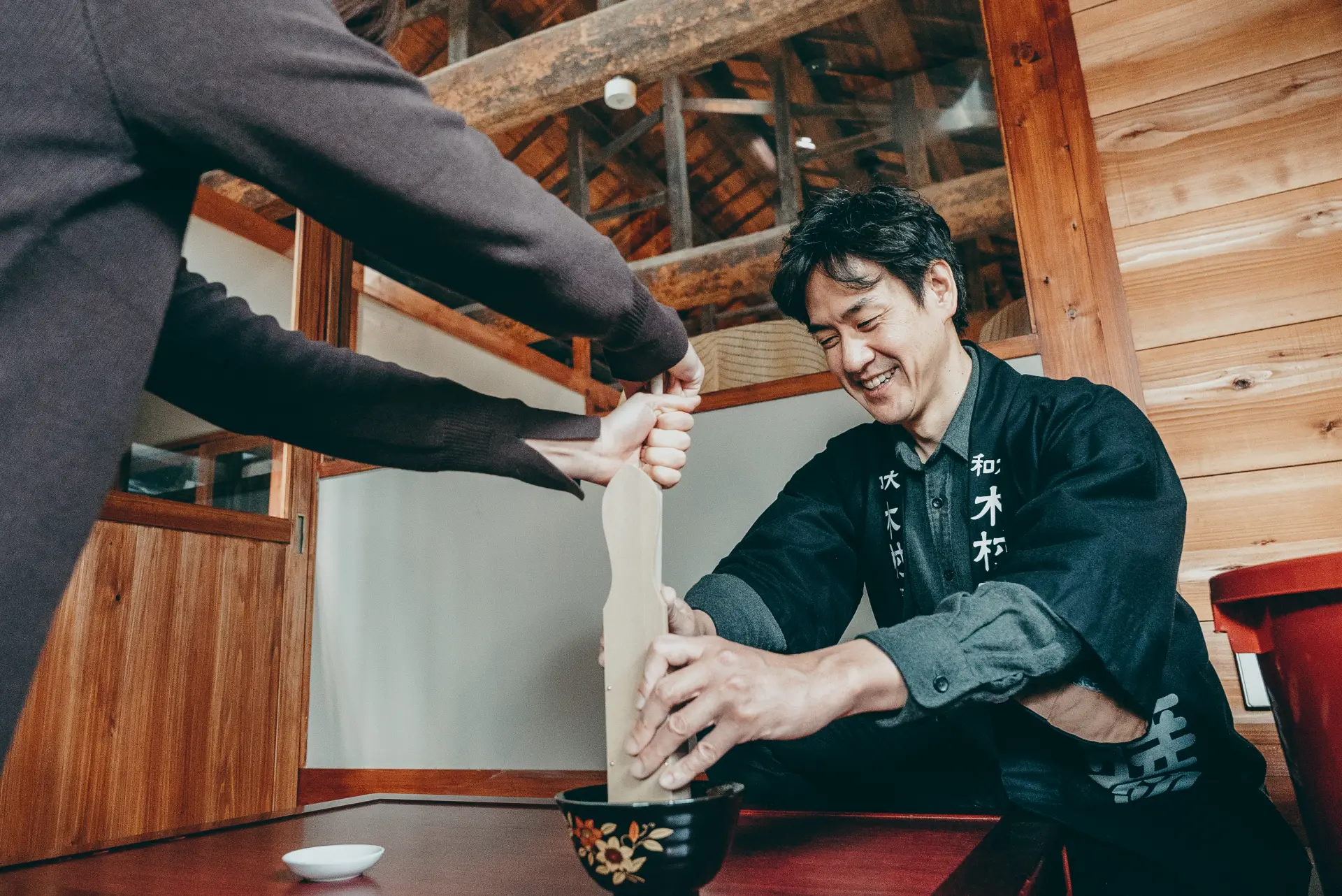 Experience fermentation culture through a hands-on soy sauce pressing activity.