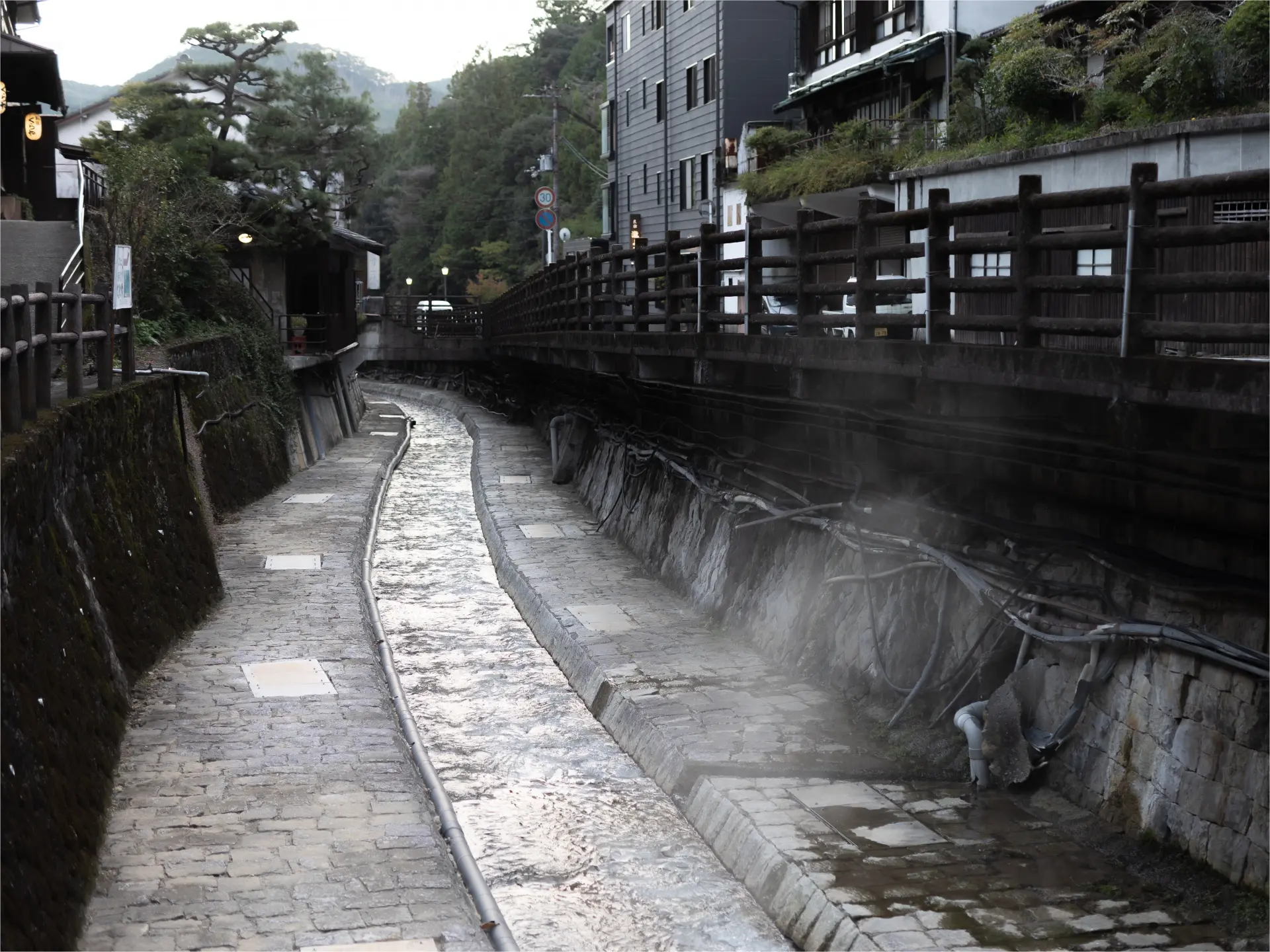 Gentle puffs of steamed air lilt and sway from the babbling river fed by natural hot springs, giving way to a nostalgic warmth as the town slips into dusk.  