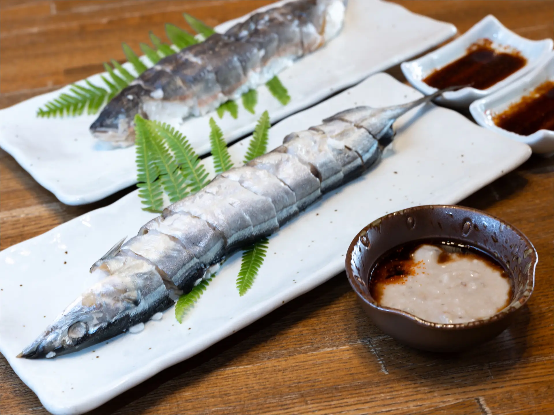 In the foreground is sanma (Pacific saury), while in the back is ayu (sweetfish). The round container holds fish that has been fermented for 30 years. Other varieties available include saba (mackerel) and amago (red-spotted trout).